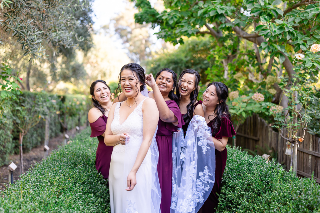 bride with bridesmaids in lush outdoor garden