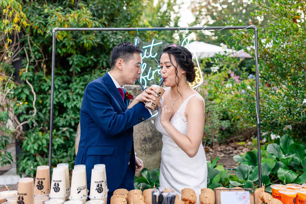 bride and groom sharing a cup of boba at the boba station