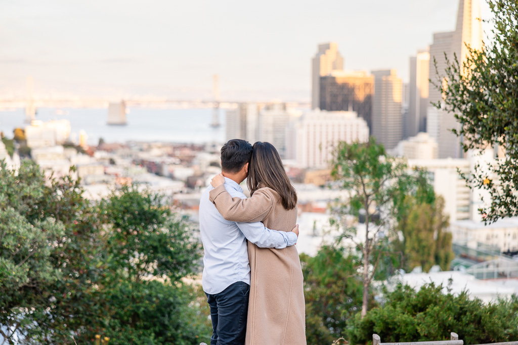 couple looking out towards the San Francisco skyline at sunset