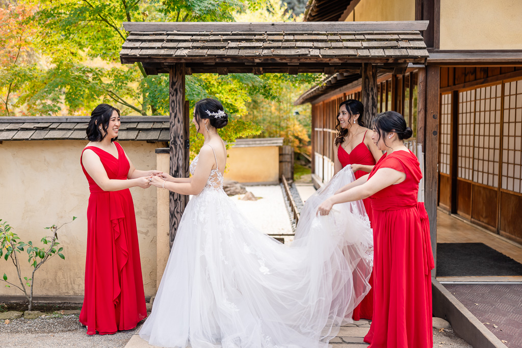 a cute moment between bride and bridesmaids outside in garden