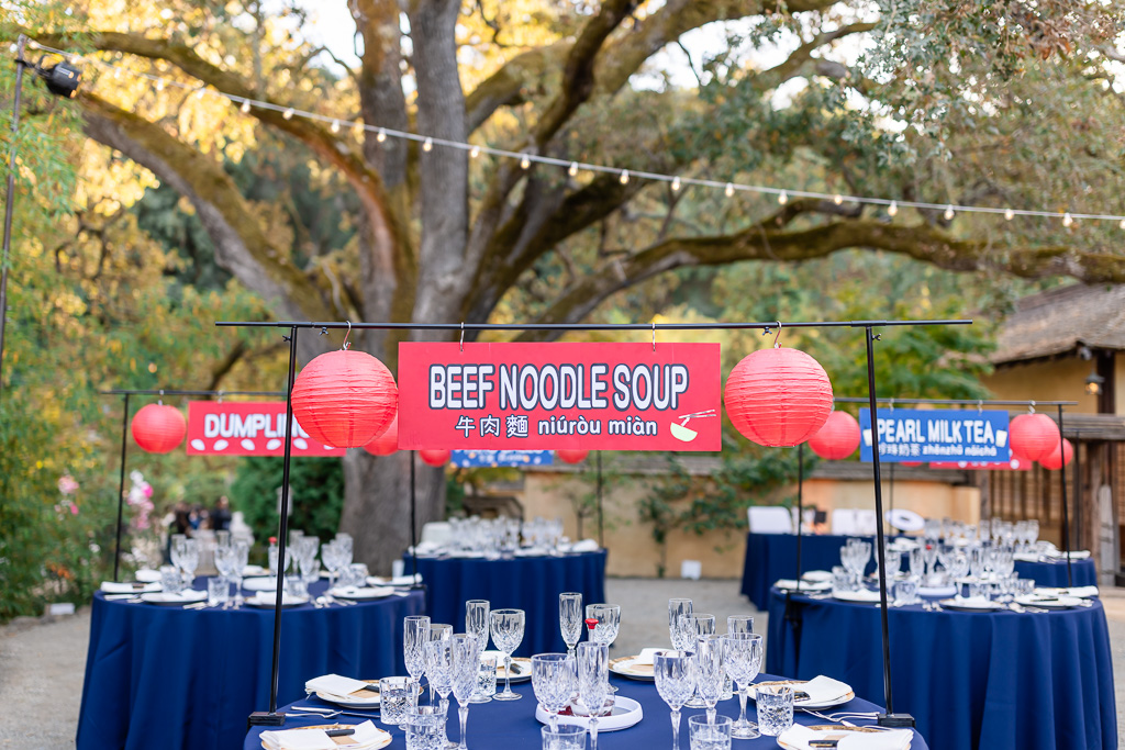 Asian night market themed wedding reception with different food stations as table decor