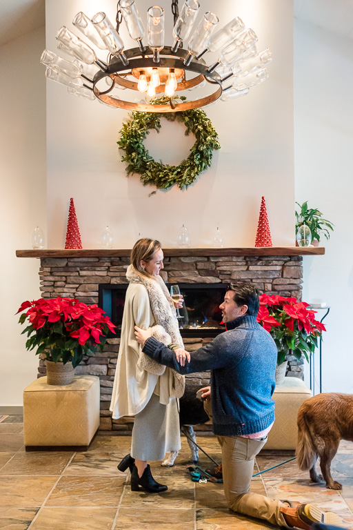 engagement proposal at a fireplace with holiday decorations