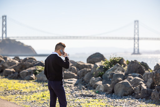 groom-to-be sneakily coordinating proposal plans on the phone