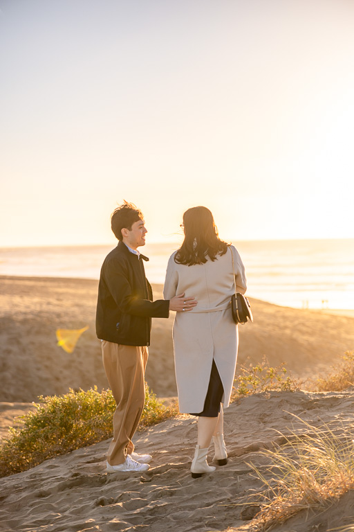 giving proposal speech on a beach with golden sun flare