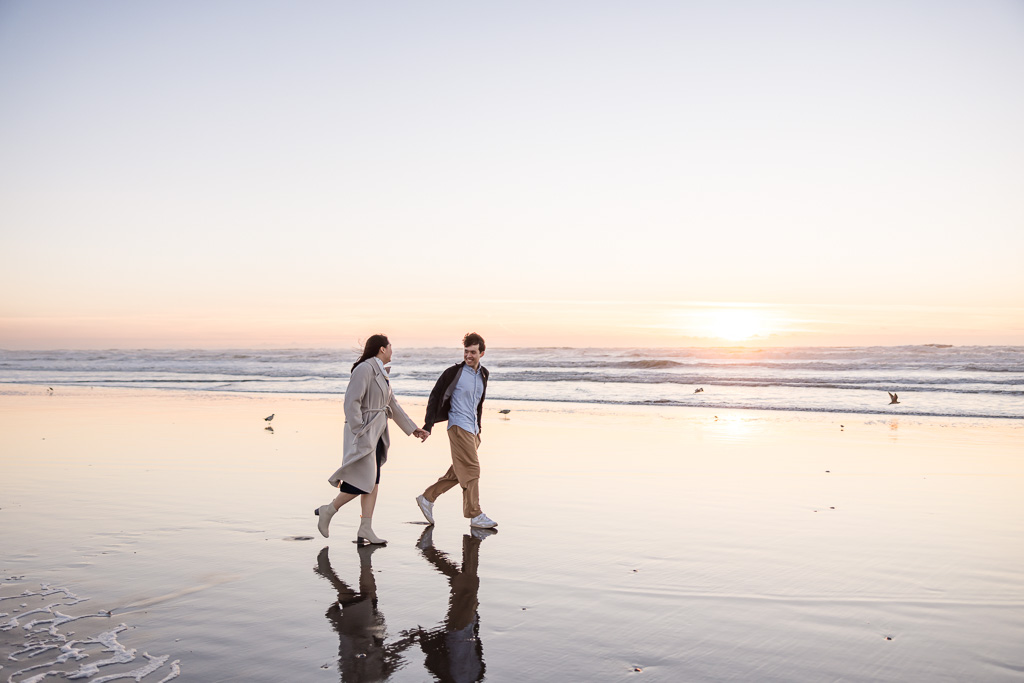 engagement photos with reflections on wet sand at the beach