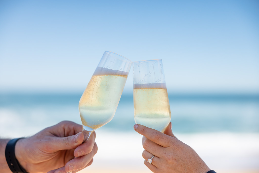 champagne toast photo on a sunny beach with blue sky