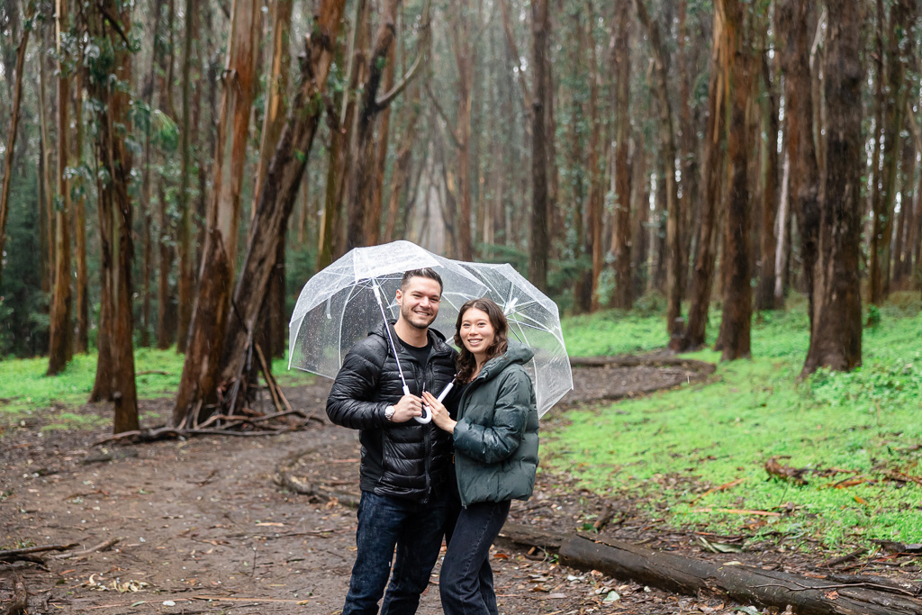 rainy portrait of a couple in the woods