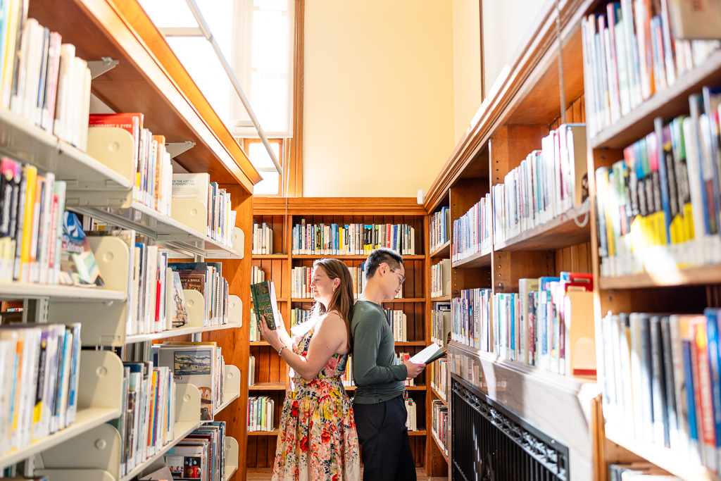 engagement photos at the library bookshelves