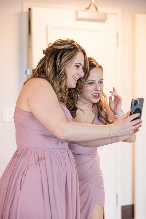 two bridesmaids taking a selfie together