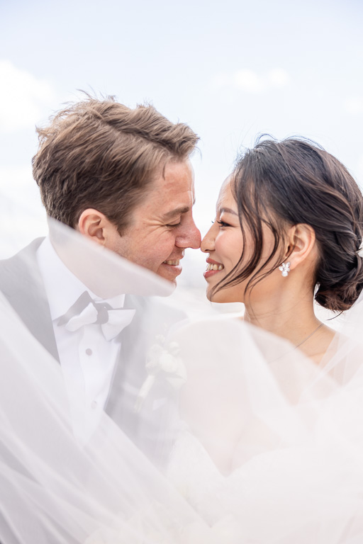 close-up veil photo with bride and groom on wedding day