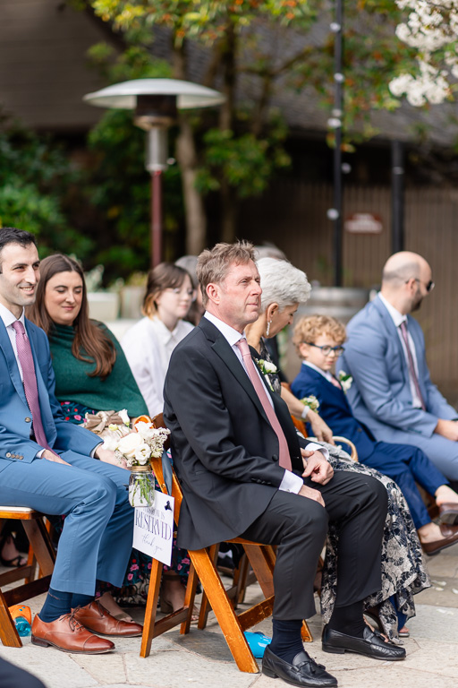 parents of the groom sitting in the audience during wedding ceremony