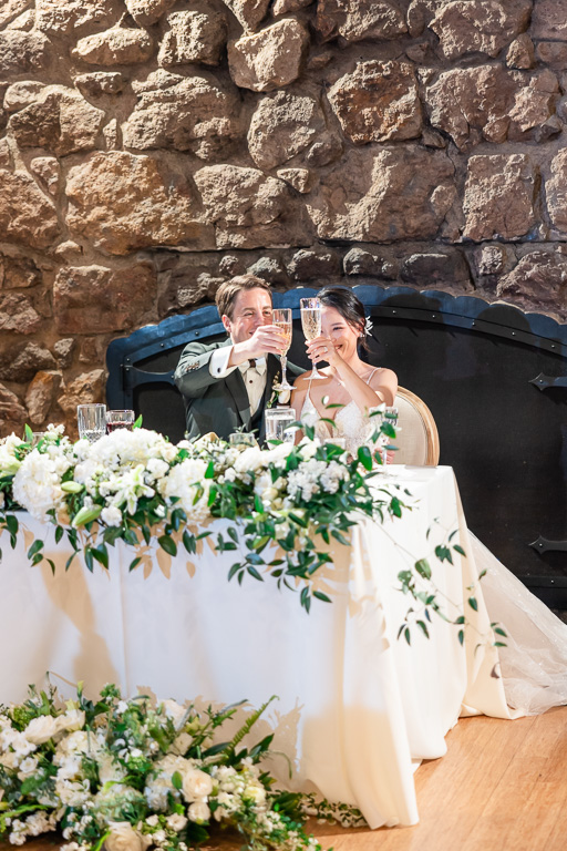 bride and groom holding up champagne glasses