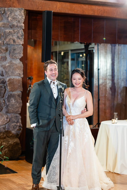 bride and groom giving a thank-you speech during dinner