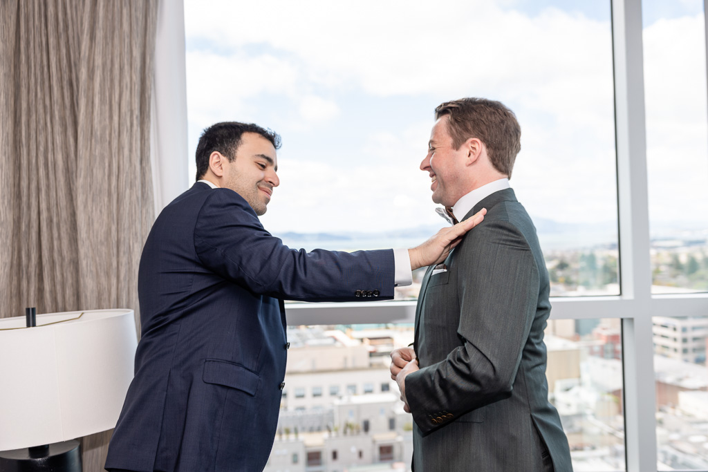 best man and groom sharing a moment in the morning