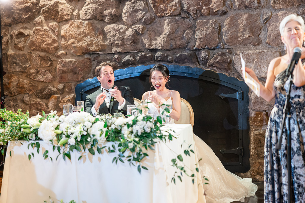 bride & groom laughing at dinner speeches