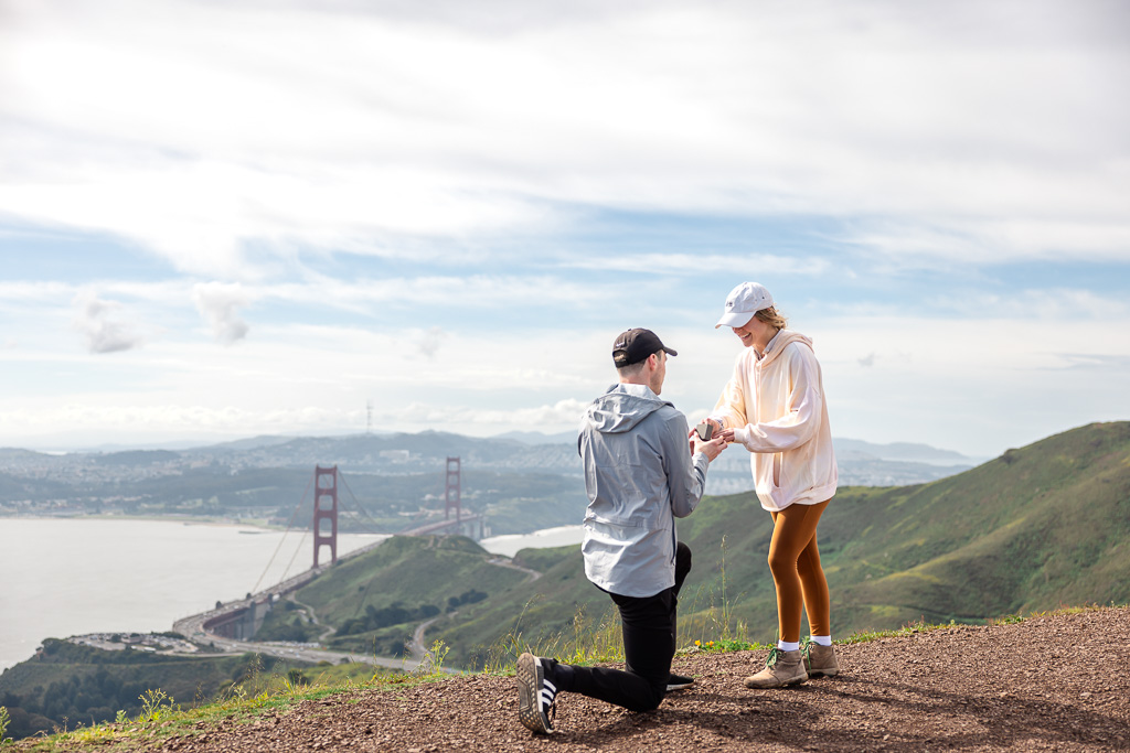 Marin hiking trail surprise engagement with Golden Gate Bridge in the background