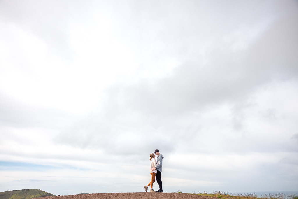 creative engagement photos with blue skies and puffy clouds