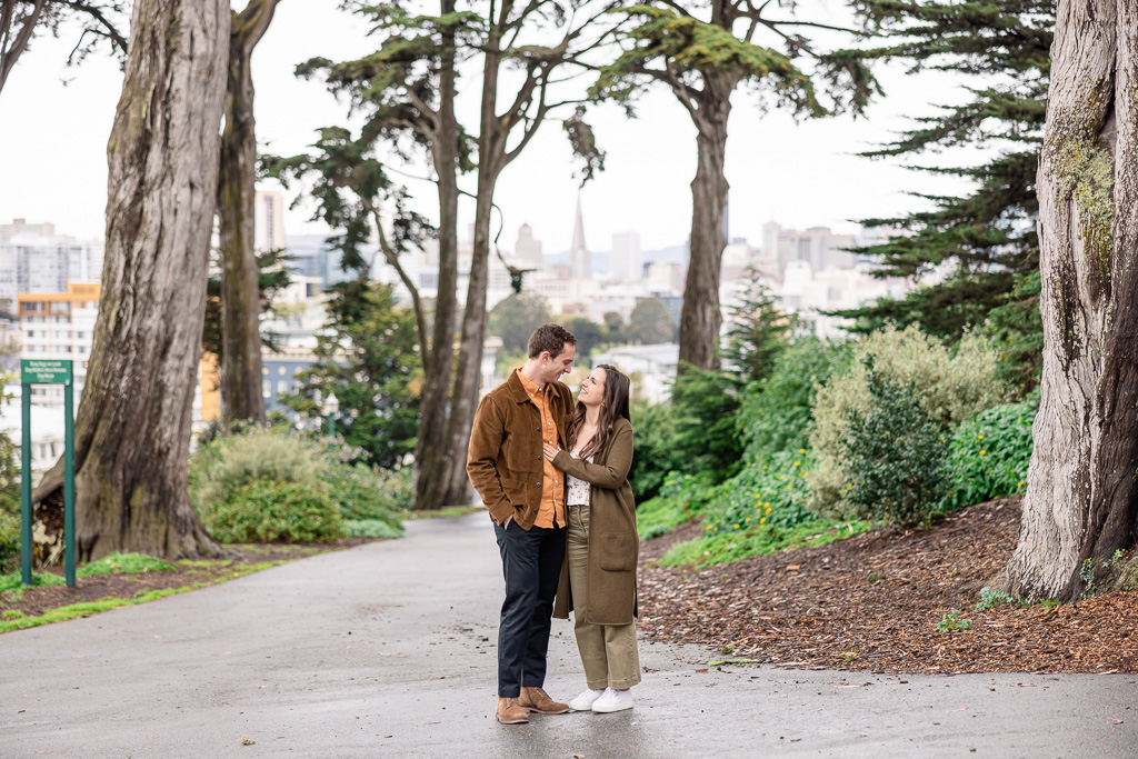 engagement photos at a park with Transamerica Pyramid in the background