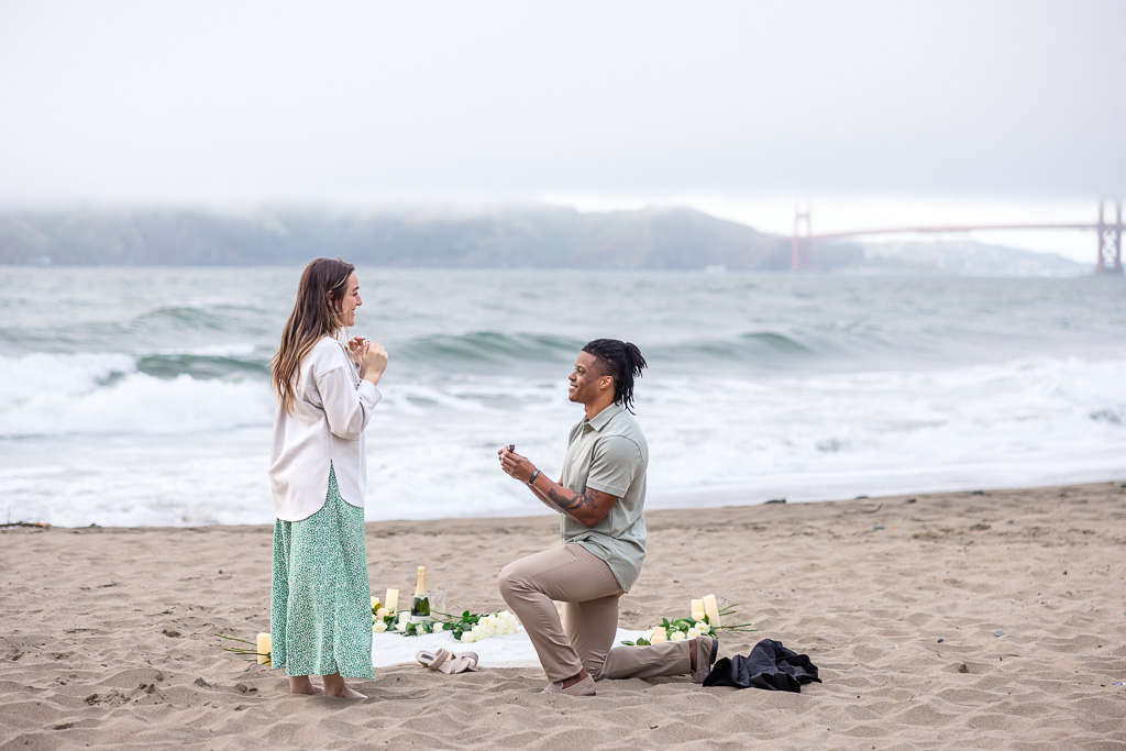 surprise proposal at China Beach with flowers and candles