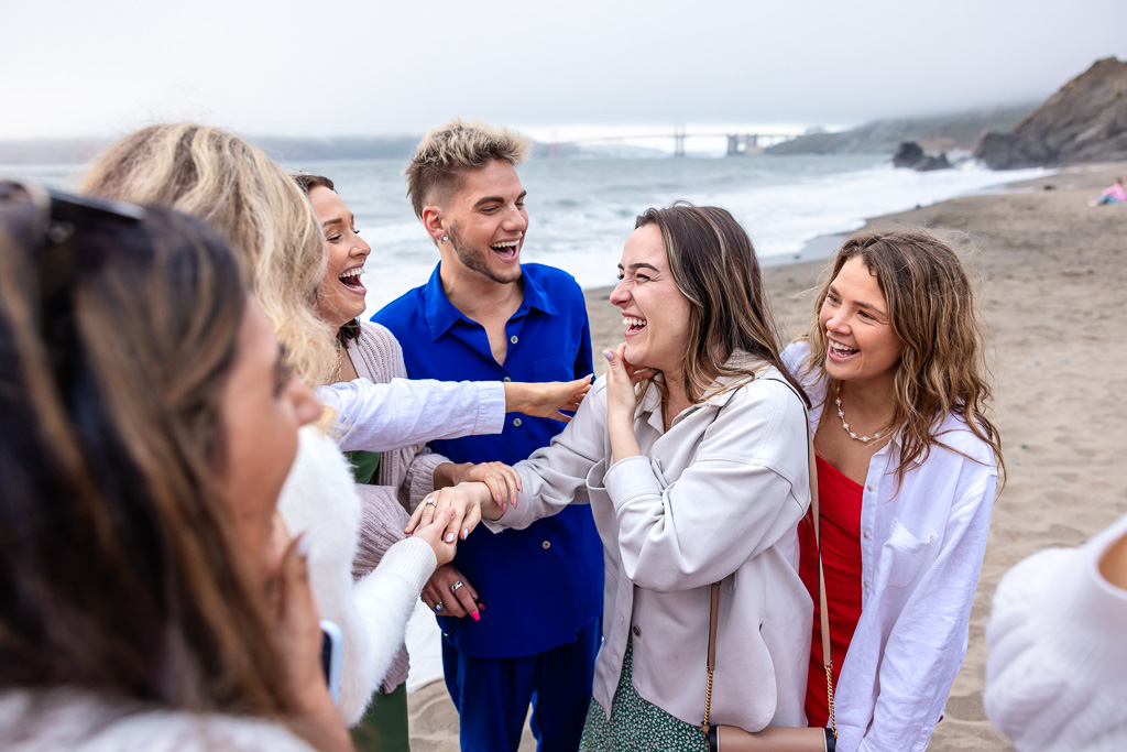 friends checking out the ring on newly engaged girl