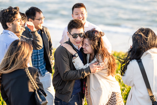 friends congratulating couple after getting engaged