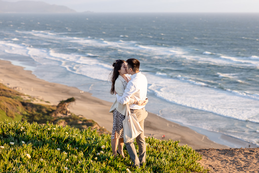 a romantic kiss on a cliff over the sea