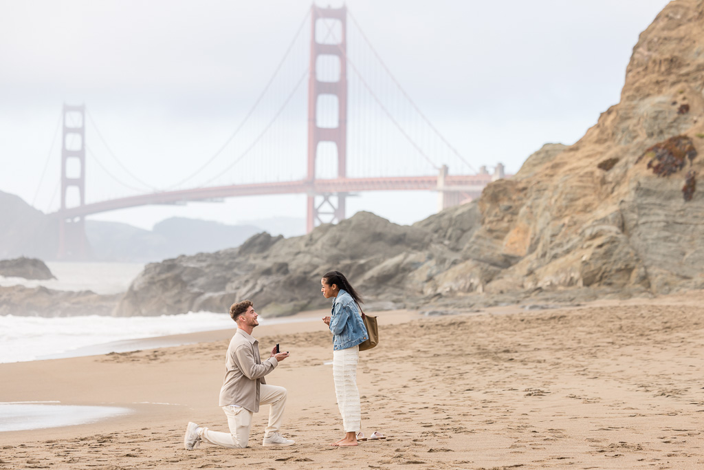 surprise proposal at Baker Beach in front of the Golden Gate Bridge