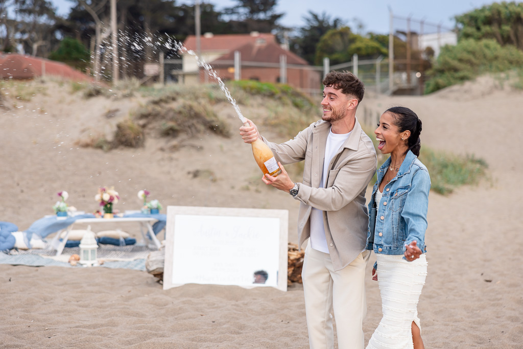 spraying champagne to celebrate engagement