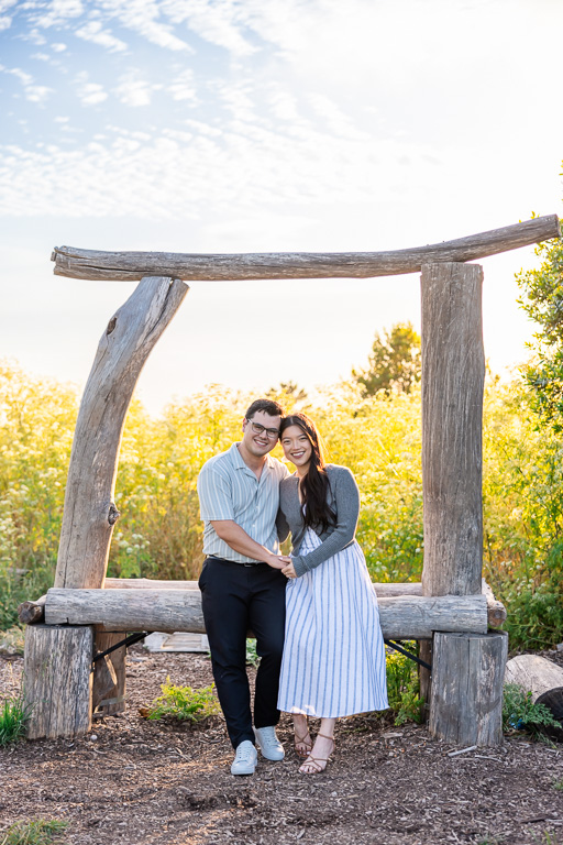 engagement photos under wooden arch