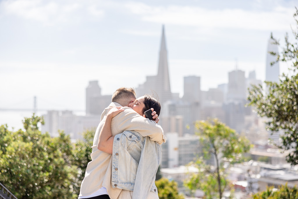 emotional hug against the backdrop of the San Francisco skyline