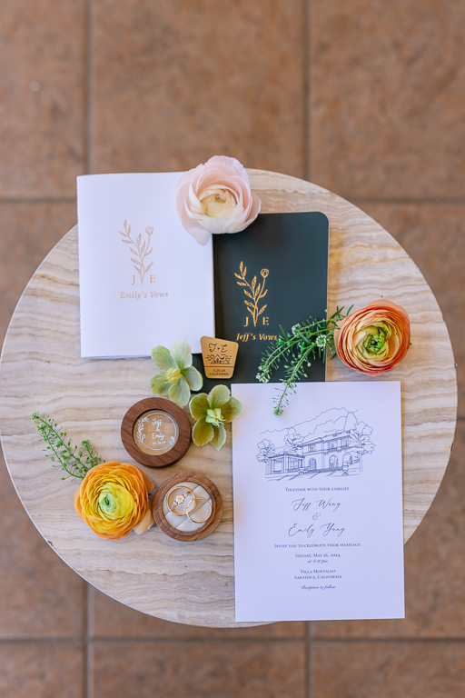 flat-lay of wedding vow books and invitations