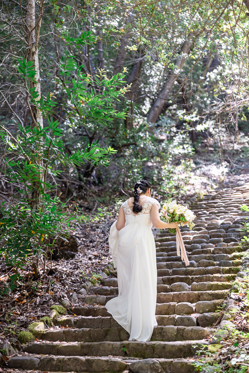 bride walking up stone steps behind Montalvo Arts Center