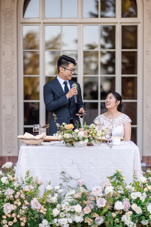 groom giving a thank-you speech from sweetheart table