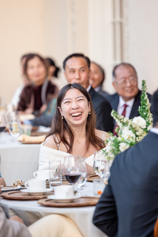 wedding guest laughing during a speech