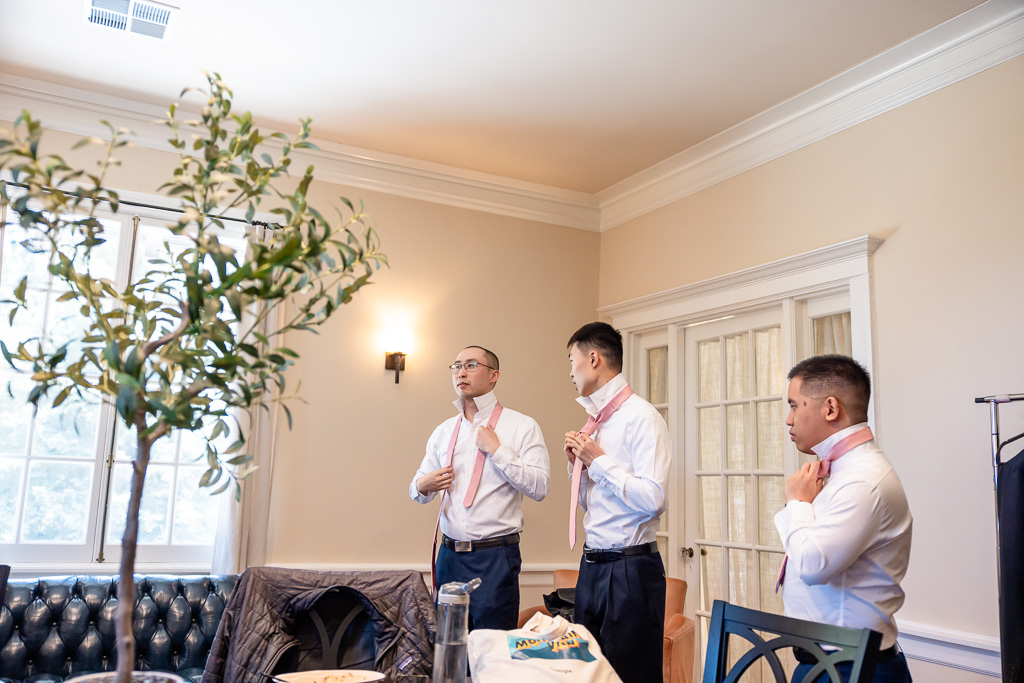 groomsmen putting on ties