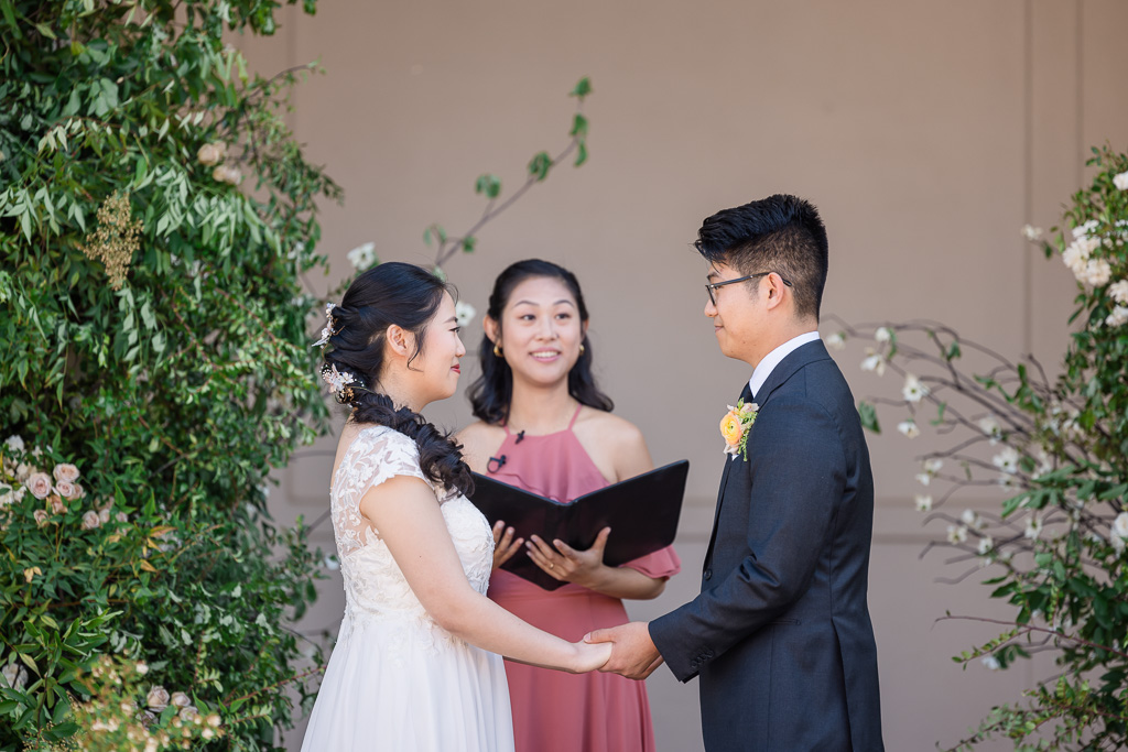 bride, groom, officiant during ceremony at Oval Garden