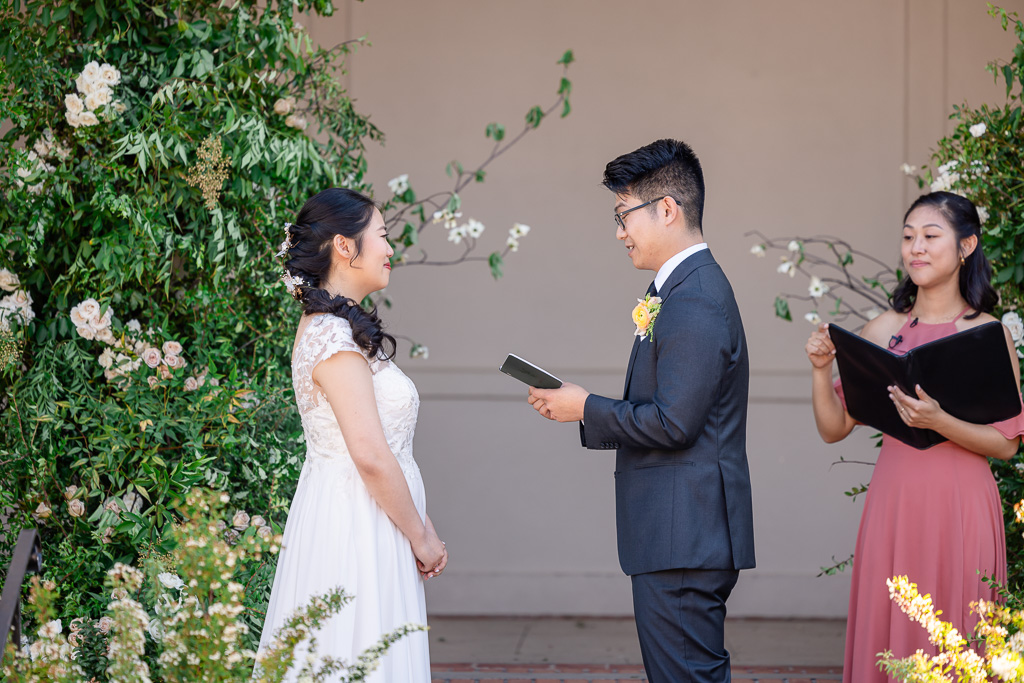 groom reading personal vows to his bride