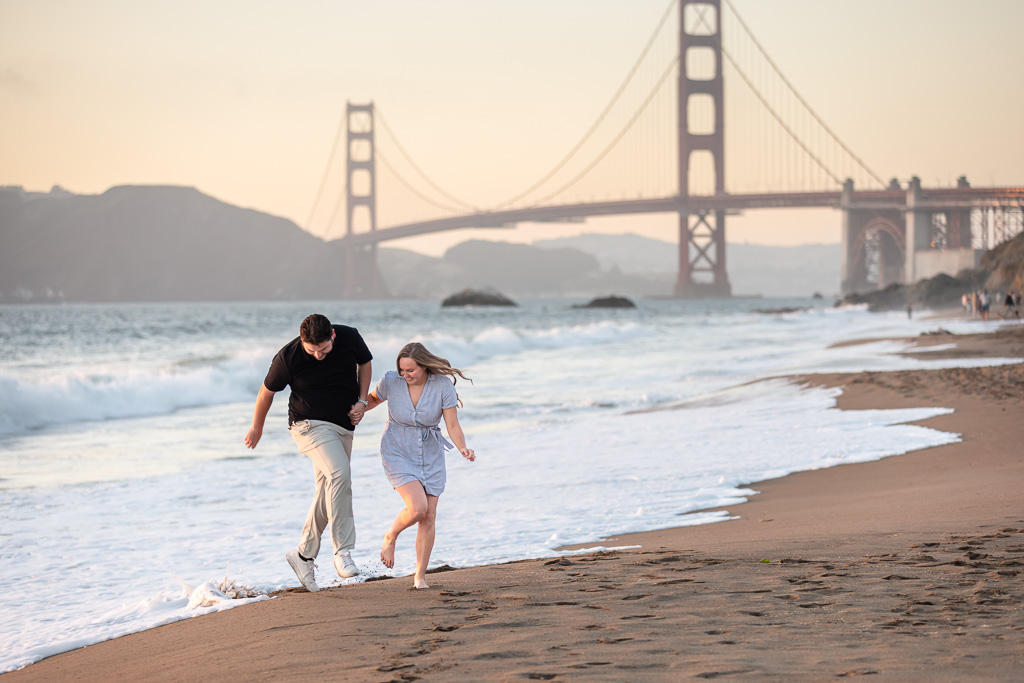 couple jumping from waves