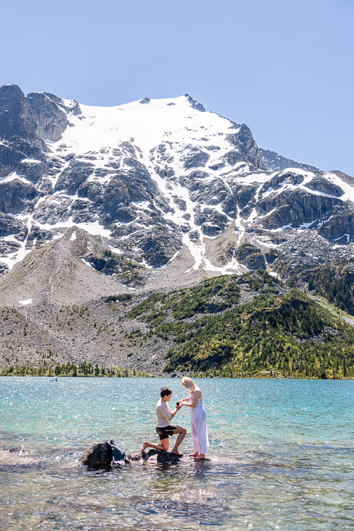 surprise proposal on a blue-green glacial lake in the mountains of British Columbia