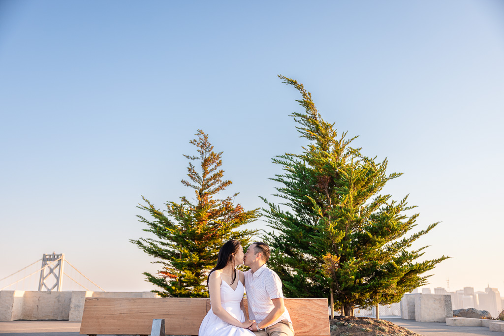 engagement photos on a wooden park bench