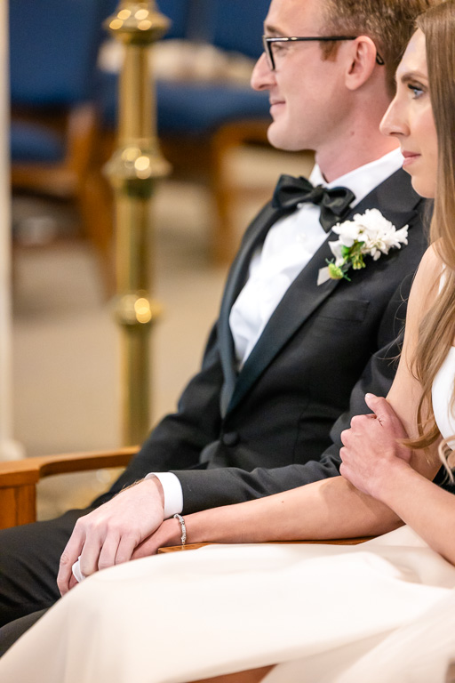 bride and groom holding hands during wedding ceremony