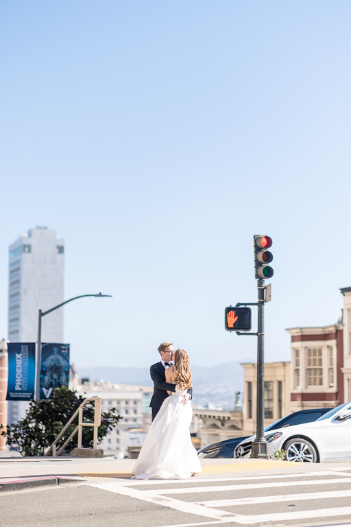 a moment of the bride and groom on a street corner in San Francisco