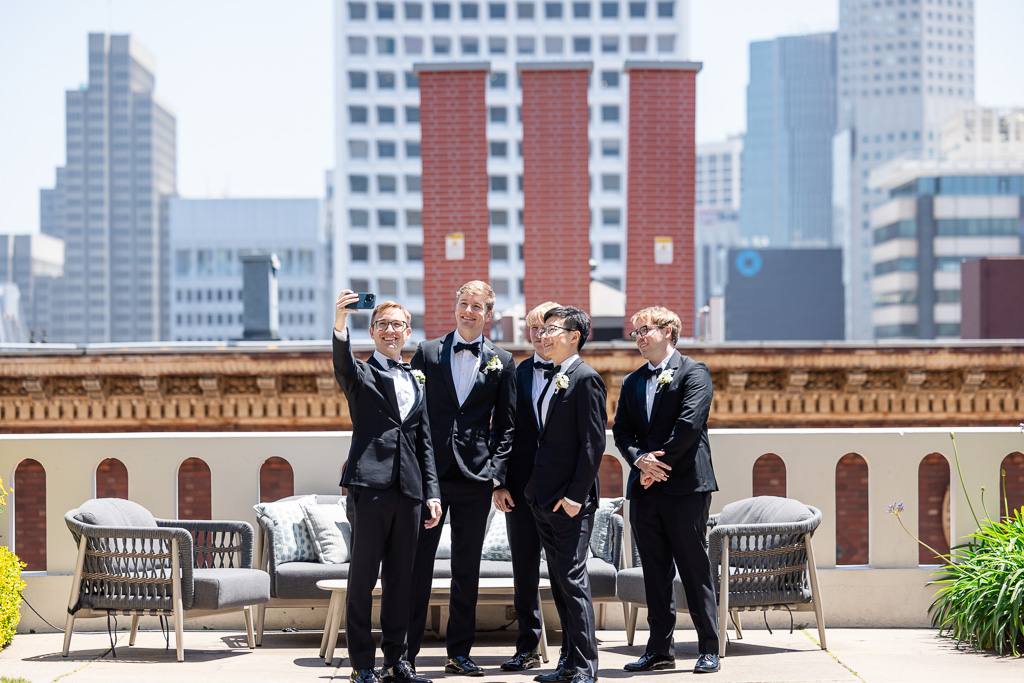 groom taking a selfie with his groomsmen