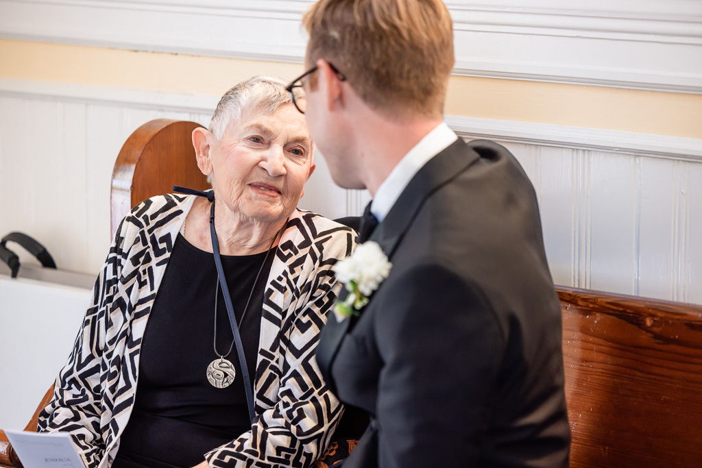 groom sharing a moment with grandma at wedding