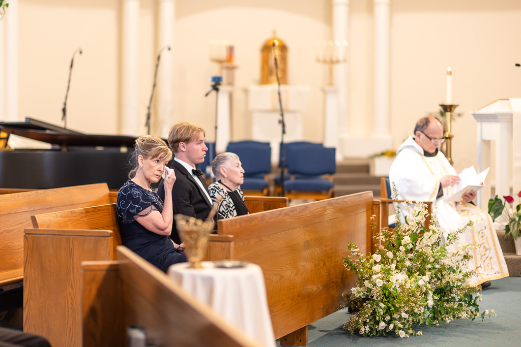 mom wiping a tear during wedding ceremony