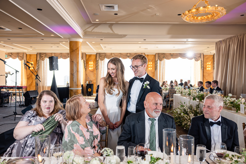 bride and groom visiting some guest tables