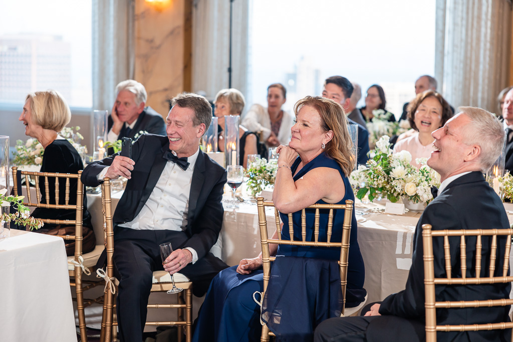 family members enjoying dinner speeches