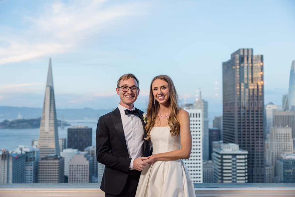 wedding photo at the Fairmont SF Crown Room with the downtown skyline in the background