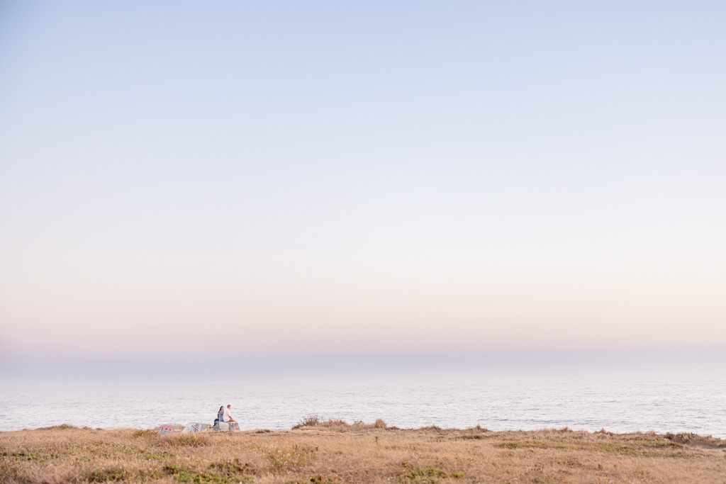 couple looking out over the ocean at sunset