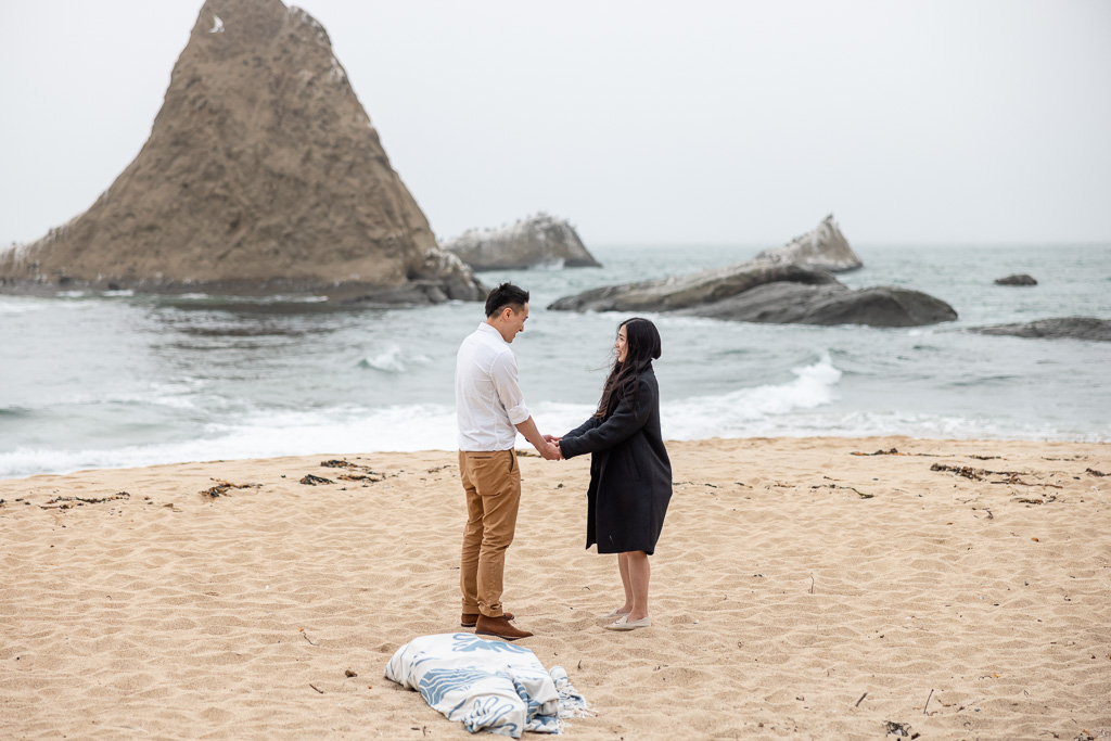 couple holding hands on the beach